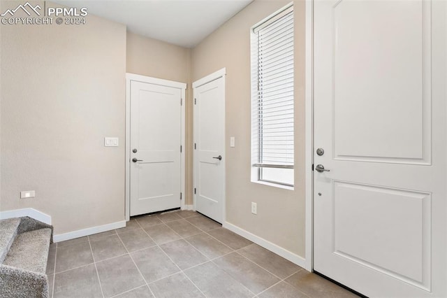 foyer entrance with tile floors