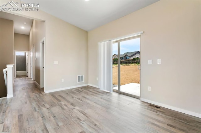 unfurnished room with hardwood / wood-style flooring