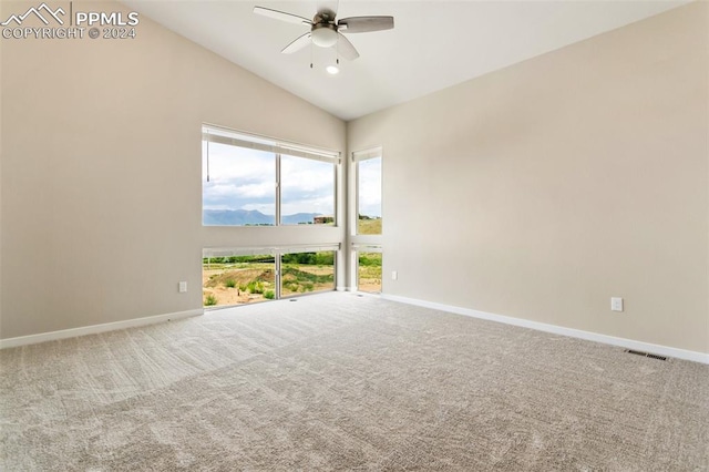 unfurnished room with carpet, ceiling fan, and vaulted ceiling