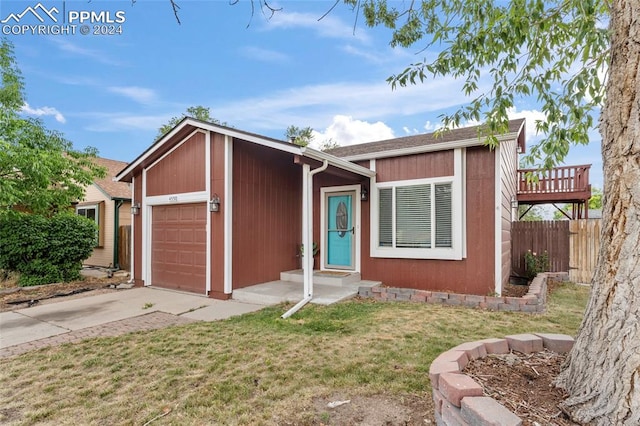 ranch-style home with a garage and a front yard