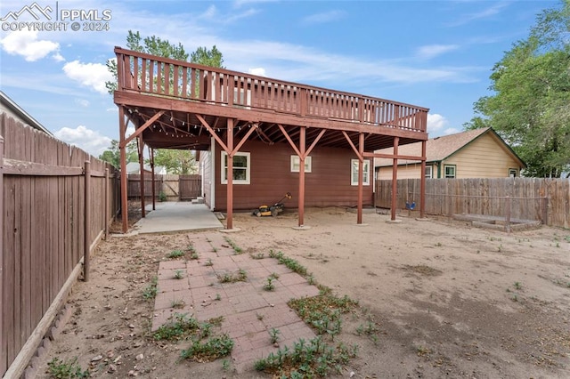 back of property with a patio and a wooden deck