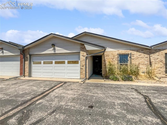 ranch-style house featuring a garage