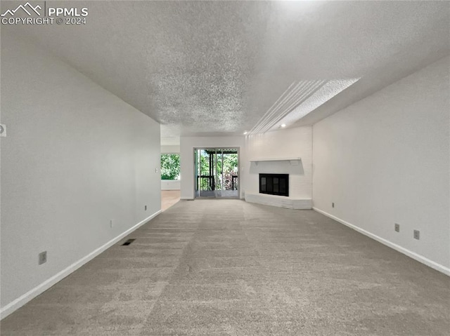 unfurnished living room featuring carpet and a textured ceiling