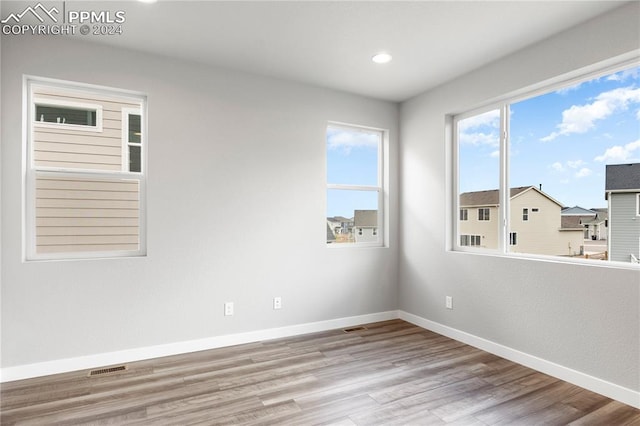 spare room with hardwood / wood-style flooring