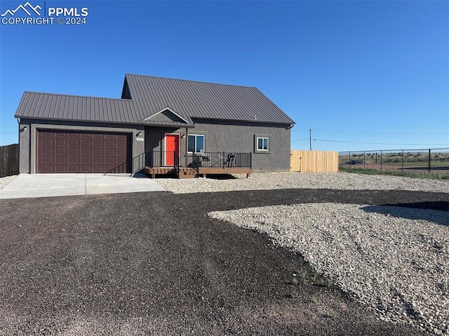 view of front of property featuring a wooden deck and a garage