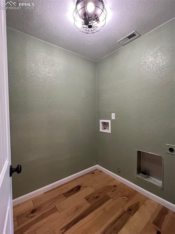 washroom featuring electric dryer hookup, washer hookup, and hardwood / wood-style flooring