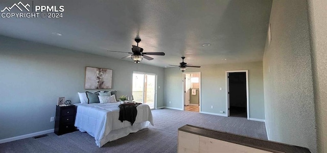 carpeted bedroom with ceiling fan, a spacious closet, and ensuite bathroom