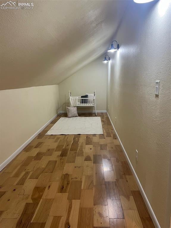 bonus room featuring hardwood / wood-style floors and lofted ceiling