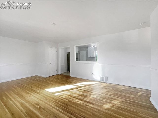 unfurnished room featuring hardwood / wood-style flooring