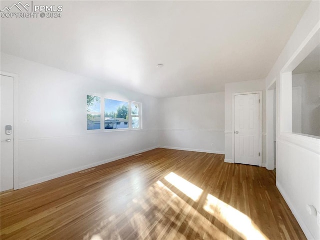 spare room featuring dark wood-type flooring