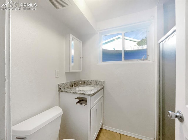 bathroom with tile patterned floors, vanity, and toilet