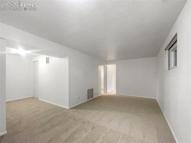 empty room with light colored carpet