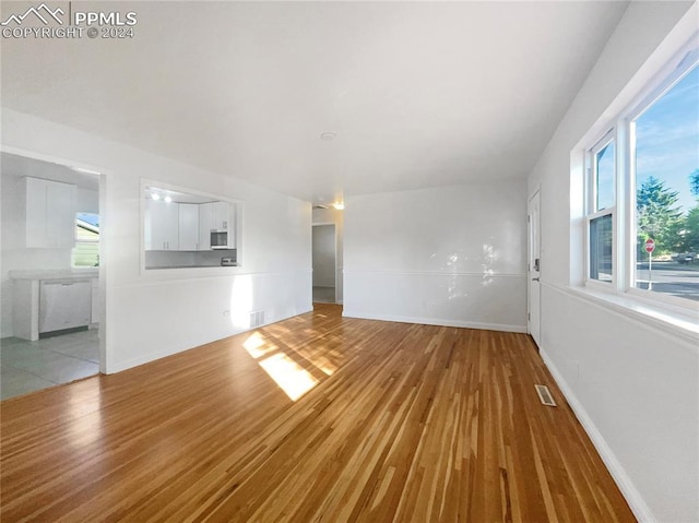 unfurnished living room with hardwood / wood-style floors