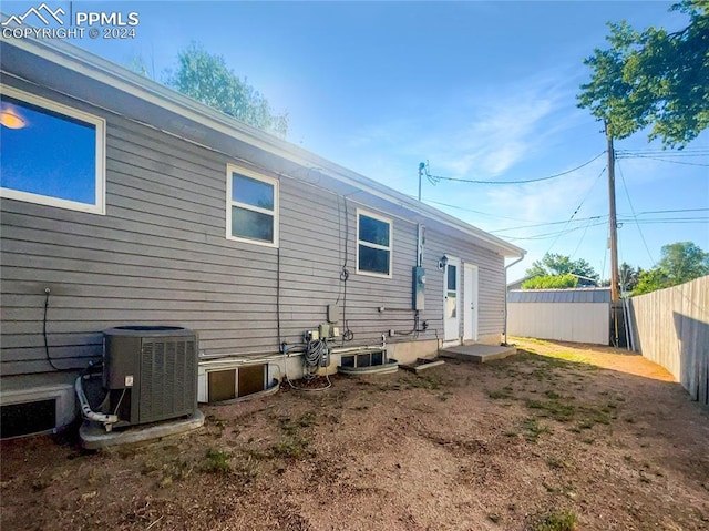 rear view of property featuring central AC