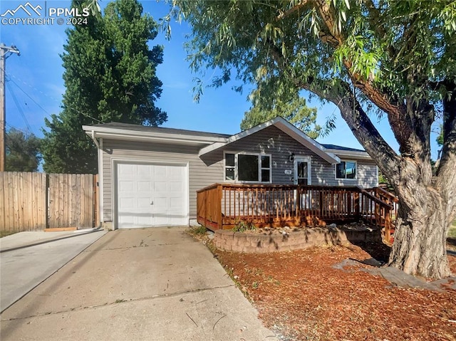 ranch-style house with a garage and a deck