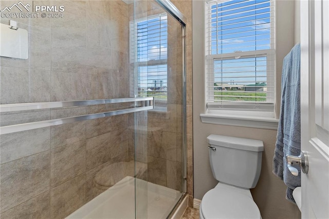 bathroom with toilet and walk in shower