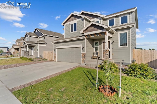 craftsman-style house featuring a front yard and a garage