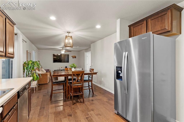 kitchen featuring ceiling fan, light hardwood / wood-style flooring, and stainless steel appliances