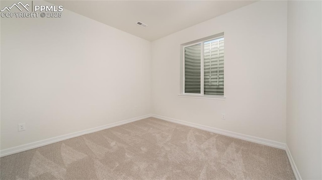 empty room with light colored carpet