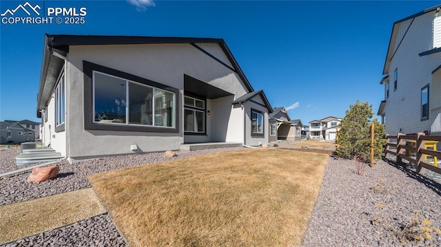 rear view of house with a lawn