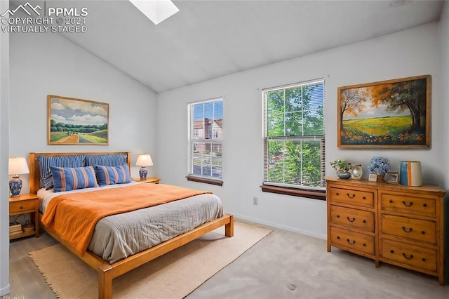 bedroom featuring lofted ceiling with skylight