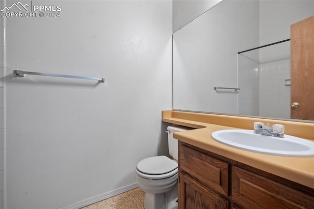 bathroom featuring a shower, vanity, and toilet