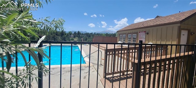 view of swimming pool featuring a mountain view and a patio