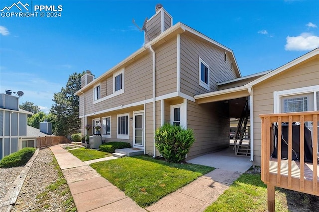 exterior space with a front lawn and central air condition unit