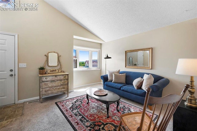 carpeted living room featuring a textured ceiling and vaulted ceiling