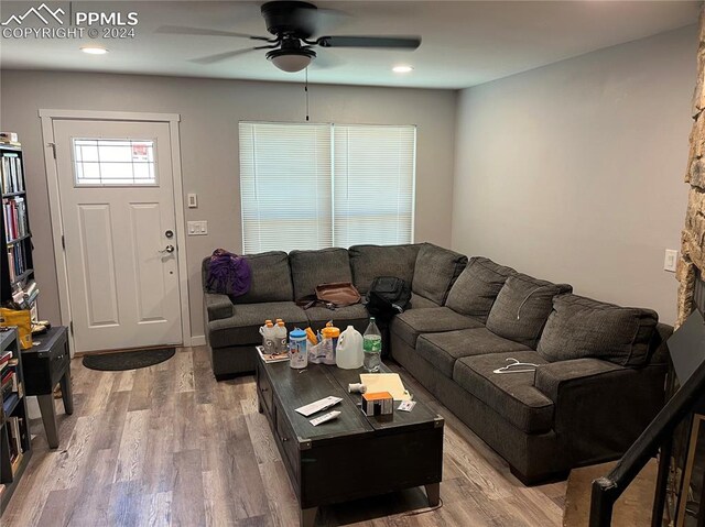 living room featuring hardwood / wood-style flooring and ceiling fan