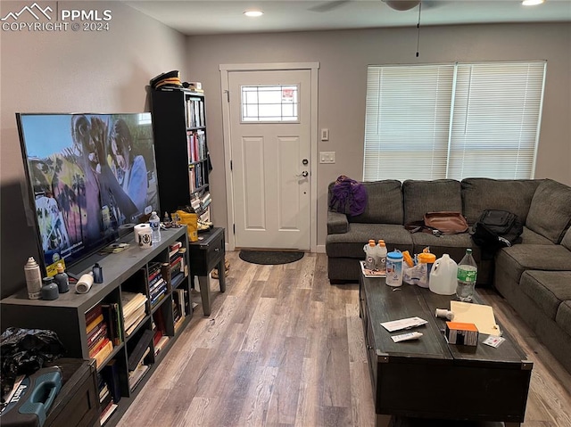 living room featuring hardwood / wood-style flooring and ceiling fan