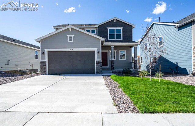 craftsman house featuring a garage, central AC, and a front yard