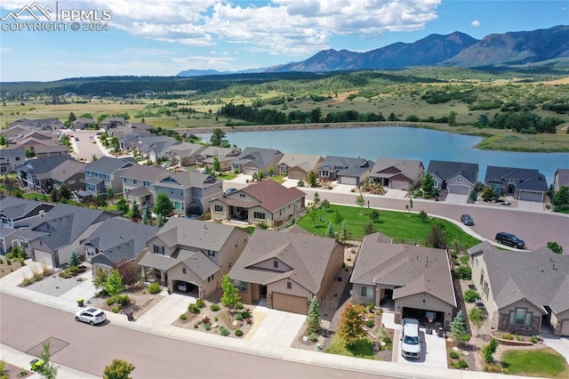 birds eye view of property featuring a water and mountain view