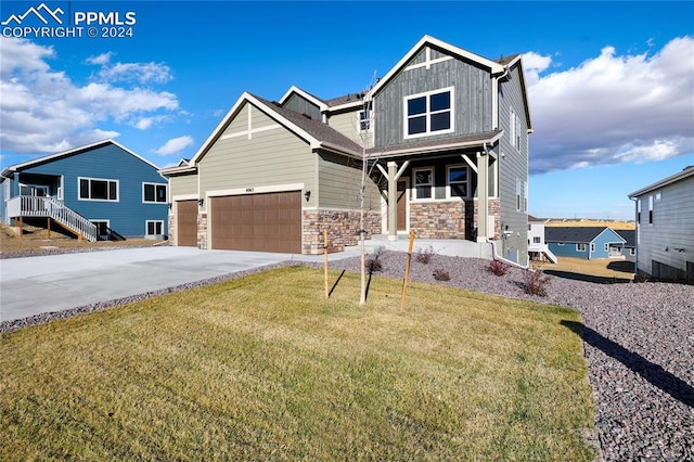 craftsman-style home with a garage and a front yard