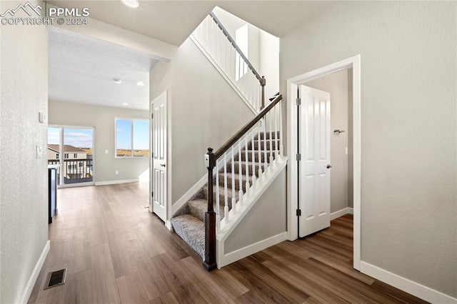 staircase with wood-type flooring