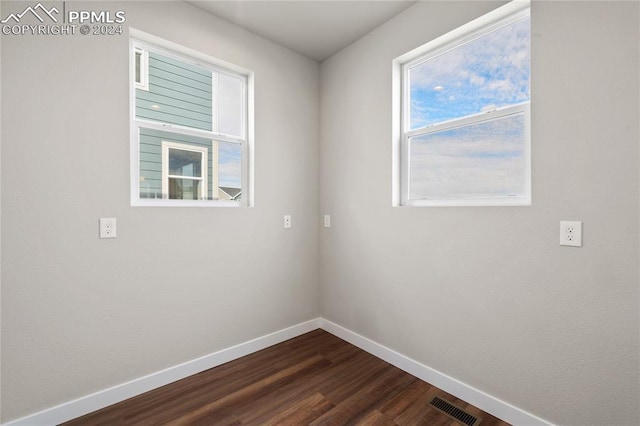 empty room with dark hardwood / wood-style floors