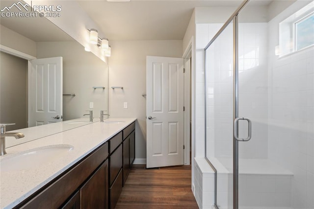 bathroom featuring vanity, a shower with shower door, and hardwood / wood-style flooring