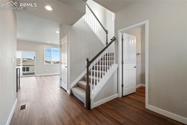 staircase with hardwood / wood-style flooring