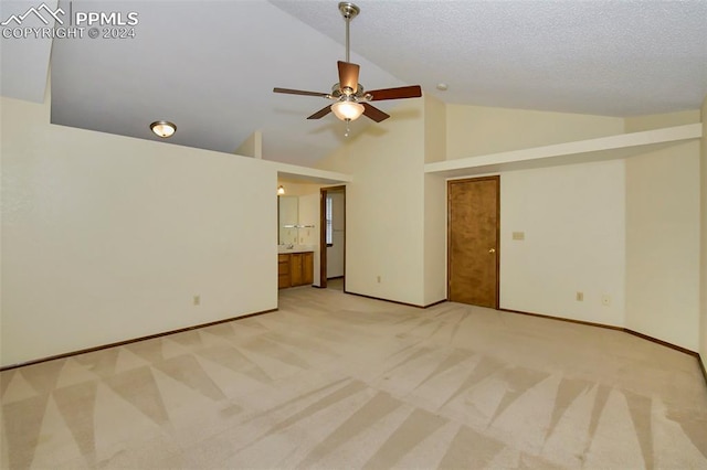 carpeted empty room with high vaulted ceiling, ceiling fan, and a textured ceiling