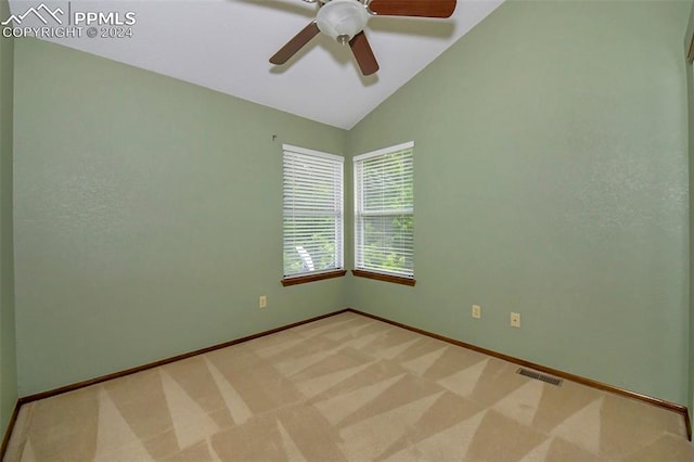 carpeted empty room featuring lofted ceiling and ceiling fan