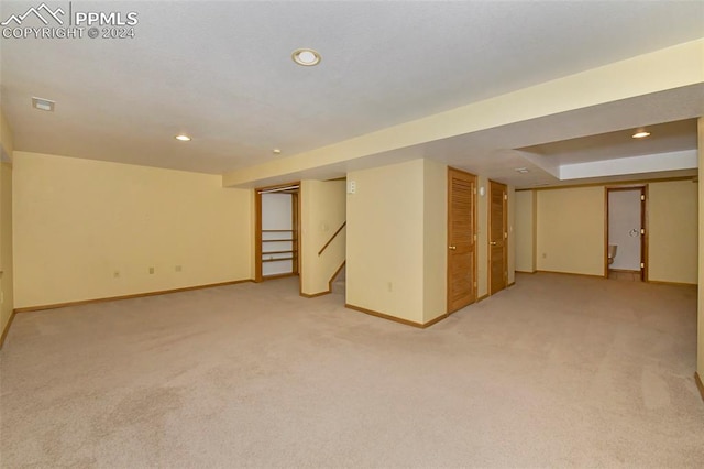 basement with light colored carpet