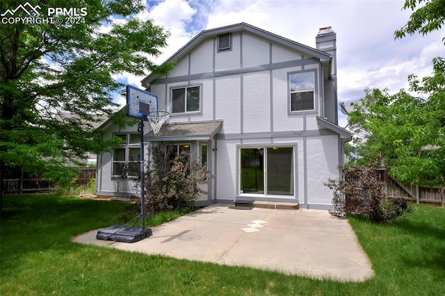 rear view of house with a yard and a patio