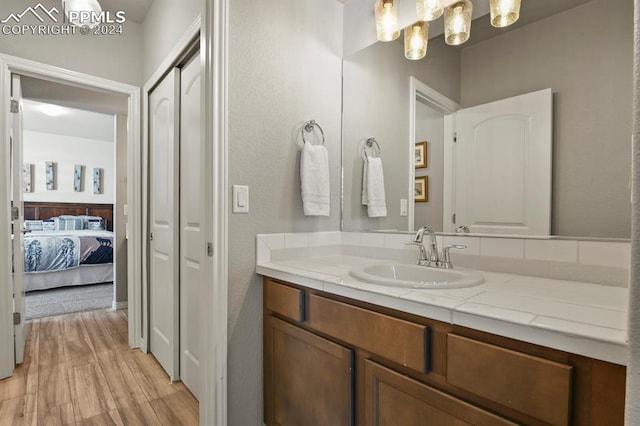 bathroom with hardwood / wood-style floors and vanity