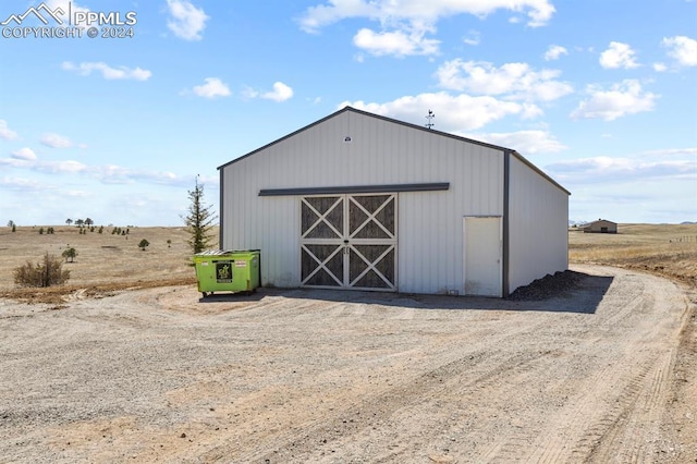 view of outbuilding with a rural view