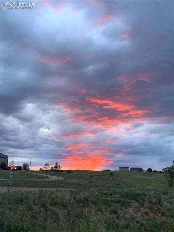 yard at dusk with a rural view