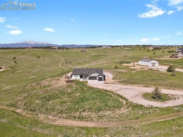 birds eye view of property with a mountain view and a rural view