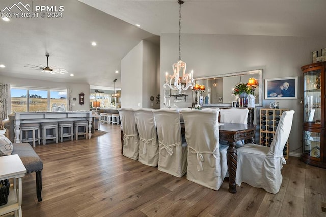 dining room featuring hardwood / wood-style floors, ceiling fan with notable chandelier, and lofted ceiling