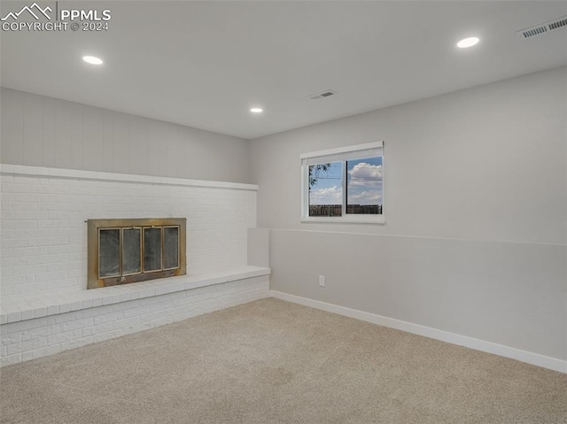 unfurnished living room featuring carpet floors and a fireplace