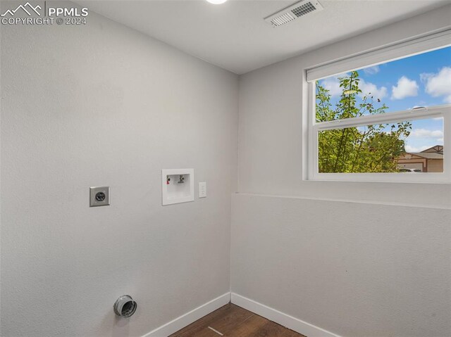 laundry room featuring electric dryer hookup, washer hookup, and dark hardwood / wood-style floors