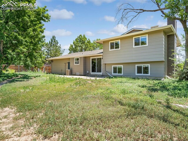 rear view of house with a lawn